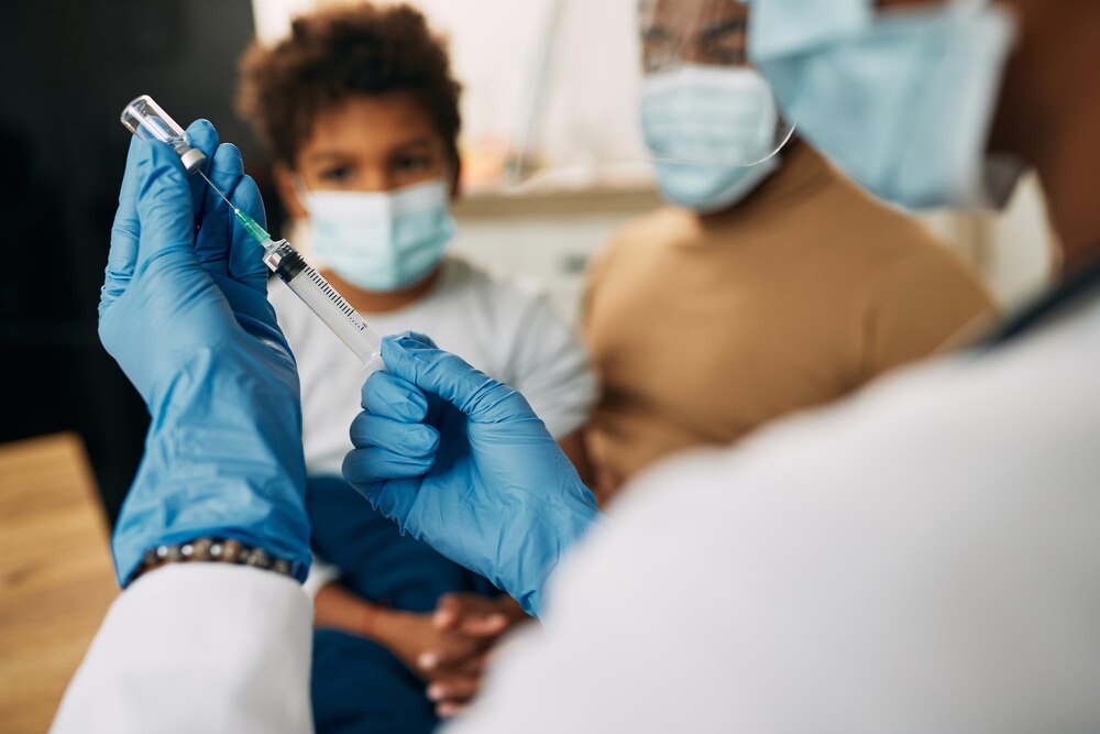 Closeup of a pediatrician preparing vaccine for a child